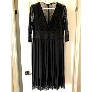 Black dress, stay in pleats waist down, deep v, lace detail. medium